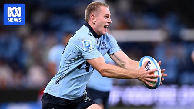 Max Jorgensen holds the ball in both hands for the Waratahs.