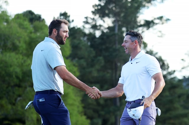 AUGUSTA, GEORGIA - APRIL 11: Scottie Scheffler of the United States and Rory McIlroy of Northern Ireland shake hands on the 18th green during the first round of the 2024 Masters Tournament at Augusta National Golf Club on April 11, 2024 in Augusta, Georgia. (Photo by Andrew Redington/Getty Images)