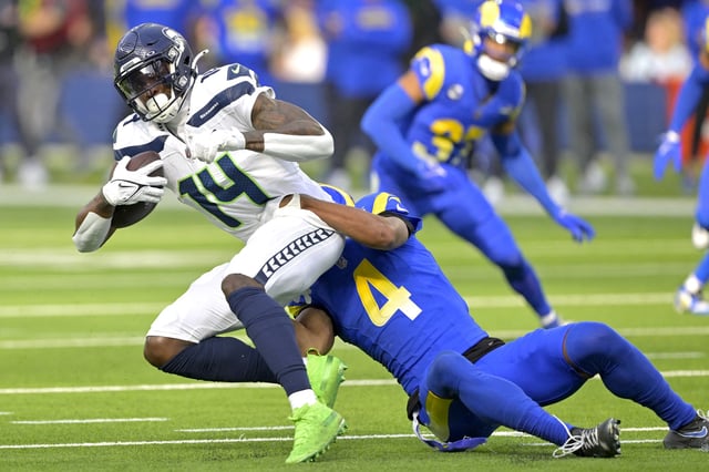 Jan 5, 2025; Inglewood, California, USA; Seattle Seahawks wide receiver DK Metcalf (14) is stopped by Los Angeles Rams cornerback Ahkello Witherspoon (4) after a complete pass in the first half at SoFi Stadium. Jayne Kamin-Oncea-Imagn Images/File Photo