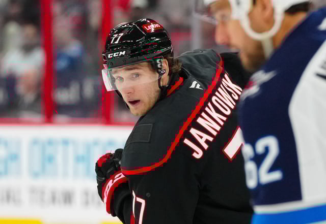 Mar 9, 2025; Raleigh, North Carolina, USA;  Carolina Hurricanes center Mark Jankowski (77) skates against the Winnipeg Jets during the third period at Lenovo Center. Mandatory Credit: James Guillory-Imagn Images