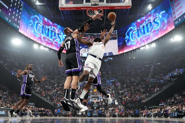 Mar 9, 2025; Inglewood, California, USA; LA Clippers guard James Harden (1) shoots the ball against Sacramento Kings center Jonas Valanciunas (17) and forward Keegan Murray (13) in the first half at Intuit Dome. Mandatory Credit: Kirby Lee-Imagn Images