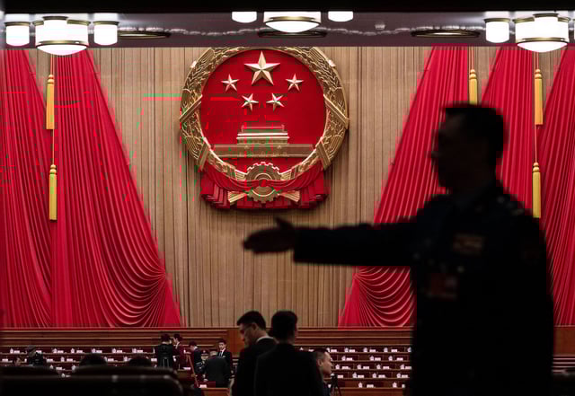 Delegates and security wait before the opening session of the National People's Congress at the Great Hall of the People in Beijing, China, on March 5, 2025.
