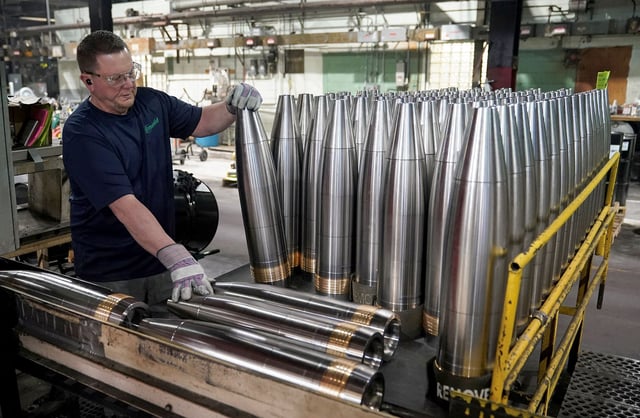 A worker along the assembly line handles large caliber 155mm metal projectiles at the Scranton Army Ammunition Plant in Scranton, Pennsylvania, U.S., April 16, 2024. REUTERS/Kevin Lamarque