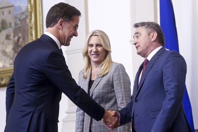 NATO Secretary General Mark Rutte, left, shakes hands with the member of the Bosnian Presidency Zeljko Komsic, right, prior to the start of their meeting in Sarajevo, Bosnia, Monday, March 10, 2025. (AP Photo/Armin Durgut)