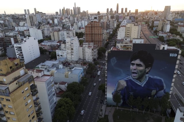 A large mural of the late soccer start Diego Maradona, by artist Martin Ron, stands in Buenos Aires, Argentina, Monday, March 10, 2025. (AP Photo/Natacha Pisarenko)