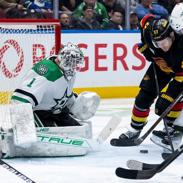Dallas Stars goaltender Casey DeSmith (1) prepares to stop Vancouver Canucks' Teddy Blueger (53) as Dallas' Mikko Rantanen (96) defends during third period NHL hockey action in Vancouver, B.C., Sunday, March 9, 2025. THE CANADIAN PRESS/Ethan Cairns