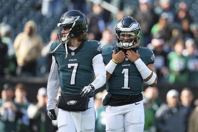 PHILADELPHIA, PENNSYLVANIA - DECEMBER 8: Kenny Pickett #7 and Jalen Hurts #1 of the Philadelphia Eagles look on prior to the game against the Carolina Panthers at Lincoln Financial Field on December 8, 2024 in Philadelphia, Pennsylvania.
