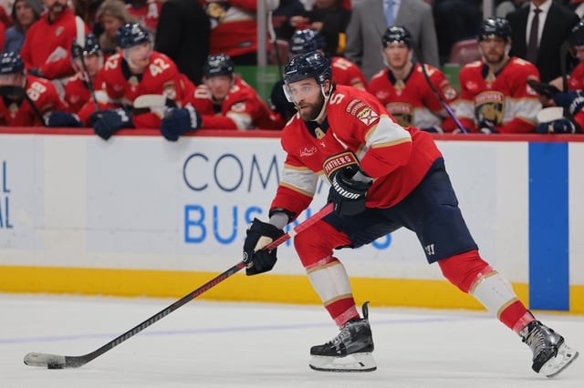 Mar 3, 2025; Sunrise, Florida, USA; Florida Panthers defenseman Aaron Ekblad (5) moves the puck against the Tampa Bay Lightning during the second period at Amerant Bank Arena. Mandatory Credit: Sam Navarro-Imagn Images/File Photo