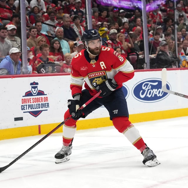 Florida Panthers defenseman Aaron Ekblad (5) skates with the puck as Calgary Flames left wing Jonathan Huberdeau (10) defends during the first period of an NHL hockey game, Saturday, March 1, 2025, in Sunrise, Fla. (AP Photo/Lynne Sladky)