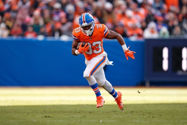 Jan 5, 2025; Denver, Colorado, USA; Denver Broncos running back Javonte Williams (33) runs the ball in the second quarter against the Kansas City Chiefs at Empower Field at Mile High. Mandatory Credit: Isaiah J. Downing-Imagn Images/File Photo