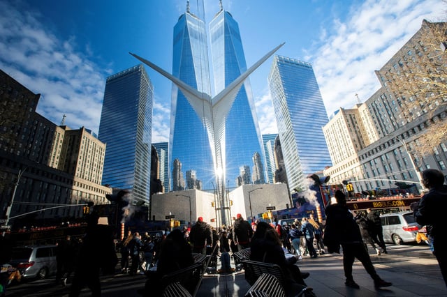 People walk around the Financial District near the New York Stock Exchange (NYSE) in New York, U.S., December 29, 2023. REUTERS/Eduardo Munoz/File photo