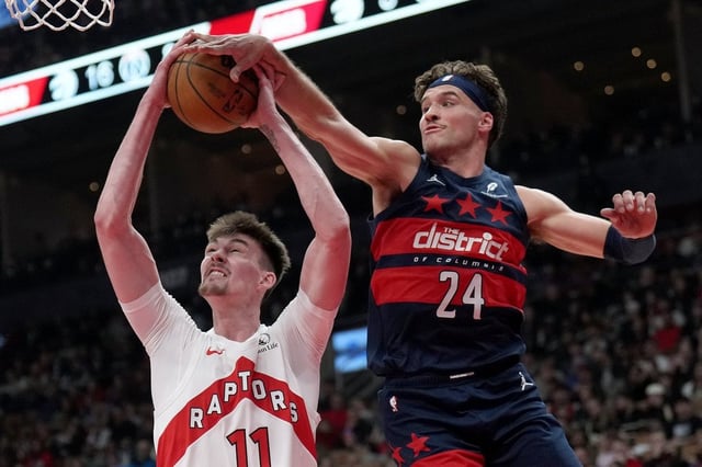 Washington Wizards forward Corey Kispert (24) rejects Toronto Raptors centre Colin Castleton (11) during first half NBA basketball action in Toronto, Monday, March 10, 2025. THE CANADIAN PRESS/Nathan Denette