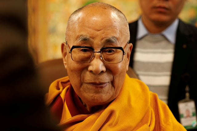 Tibetan spiritual leader, the Dalai Lama, offers blessings to his followers at his Himalayan residence in the northern hill town of Dharamshala, India, December 20, 2024. REUTERS/Priyanshu Singh/File Photo