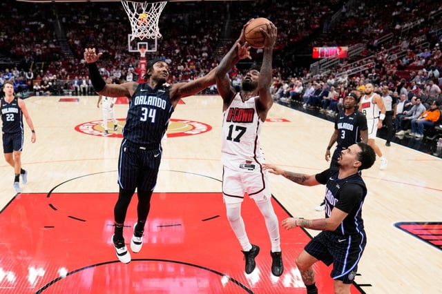 Houston Rockets&#39; Tari Eason (17) and Orlando Magic&#39;s Wendell Carter Jr. (34) reach for a rebound during the first half of an NBA basketball game Monday, March 10, 2025, in Houston. (AP Photo/David J. Phillip)