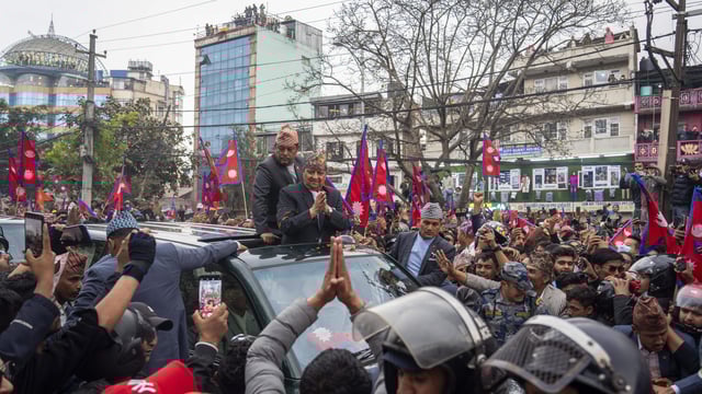 Supporters welcome Nepal's former King Gyanendra Shah upon his arrival at Tribhuvan International Airport in Kathmandu, Nepal, Sunday, March 9, 2025. 