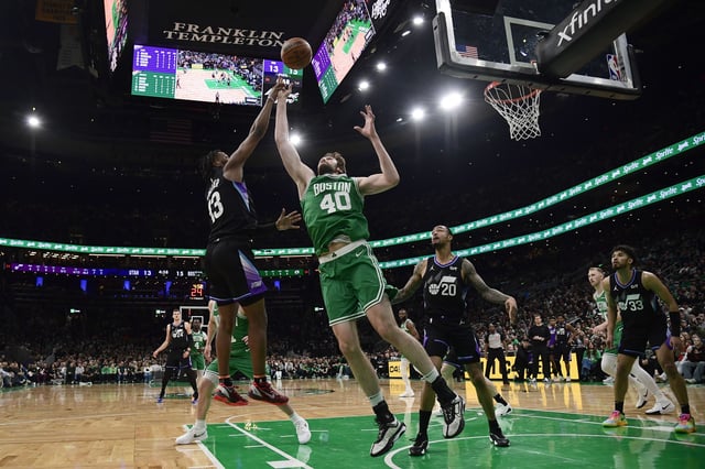 Mar 10, 2025; Boston, Massachusetts, USA; Utah Jazz guard Isaiah Collier (13) and Boston Celtics forward Sam Hauser (30) battle for the ball during the first half at TD Garden. Mandatory Credit: Bob DeChiara-Imagn Images