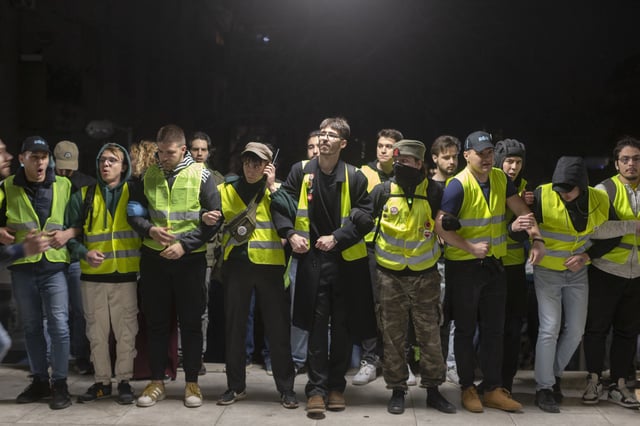 Students form a human chain as they block the public broadcaster RTS building in central Belgrade, Serbia, Monday, March 10, 2025. (AP Photo/Marko Drobnjakovic)