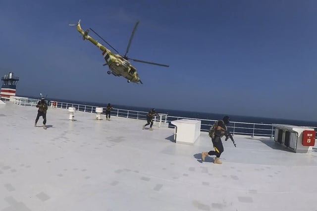 This photo released by the Houthi Media Center shows Houthi forces boarding the cargo ship Galaxy Leader on Sunday, Nov. 19, 2023.