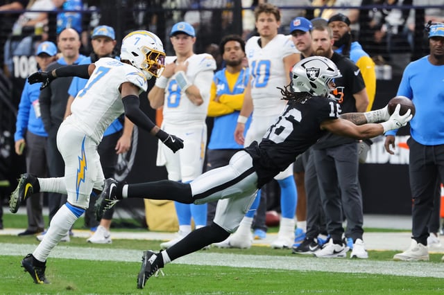 LAS VEGAS, NEVADA - JANUARY 05: Jakobi Meyers #16 of the Las Vegas Raiders makes a catch against Kristian Fulton #7 of the Los Angeles Chargers in the first quarter of their game at Allegiant Stadium on January 05, 2025 in Las Vegas, Nevada.