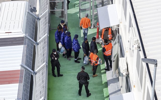FILE -An aerial photograph taken by a drone shows migrants entering a detention center for processing following earlier court rejections, in the port of Shengjin, northwestern Albania, Tuesday, Jan. 28, 2025. (AP Photo/Vlasov Sulaj, File)