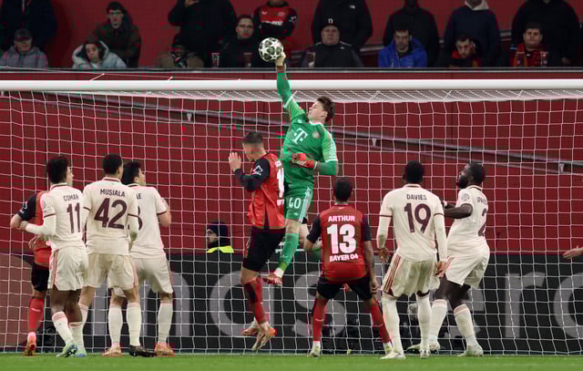 Soccer Football - Champions League - Round of 16 - Second Leg - Bayer Leverkusen v Bayern Munich - BayArena, Leverkusen, Germany - March 11, 2025 Bayern Munich's Jonas Urbig makes a save REUTERS/Wolfgang Rattay