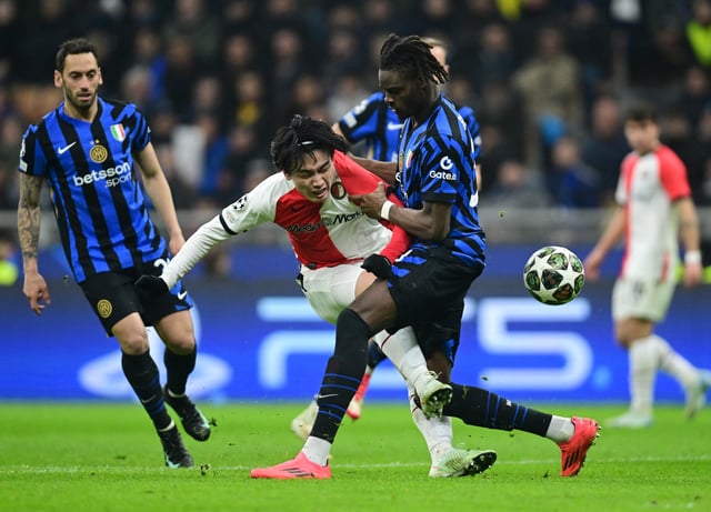 Soccer Football - Champions League - Round of 16 - Second Leg - Inter Milan v Feyenoord - San Siro, Milan, Italy - March 11, 2025 Feyenoord's Ayase Ueda in action with Inter Milan's Yann Bisseck REUTERS/Daniele Mascolo