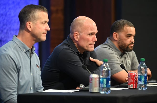 Baltimore Ravens head coach John Harbaugh, left, general manager Eric DeCosta and director of college scouting David Blackburn speak to the media following their final pick in the 2024 NFL Draft at the Owings Mills facility. (Kevin Richardson/Staff)