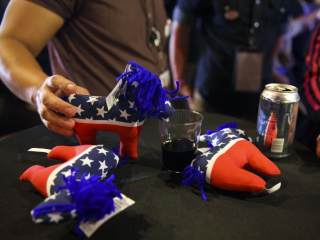 An attendee holds a donkey stuffed animal over a glass of wine during a 2016 U.S. presidential election night watch party at La Plaza de Cultura y Artes in Los Angeles, California, U.S., on Tuesday, Nov. 8, 2016. Donald Trump racked up victory after victory in key states Tuesday to put himself in position to threaten Clinton for the White House, with the results in three Rust-Belt states likely to determine the next U.S. president. Photographer: Patrick T. Fallon/Bloomberg via Getty Images