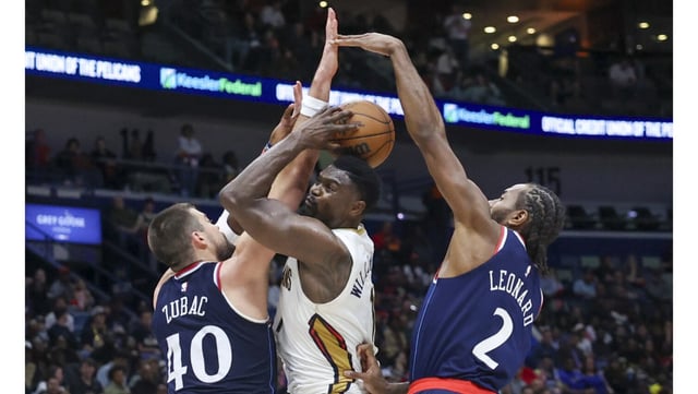 New Orleans Pelicans forward Zion Williamson, center, tries to drive to the basket between Clippers center Ivica Zubac, left, and forward Kawhi Leonard during the second half on Tuesday night in New Orleans. Williamson had a 22-point triple-double and the Pelicans held off the Clippers, 127-120. (AP Photo/Peter Forest)