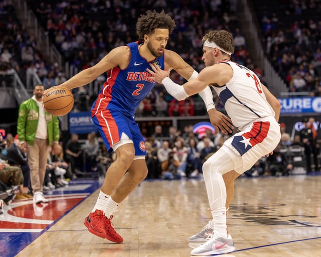 Mar 11, 2025; Detroit, Michigan, USA; Washington Wizards forward Corey Kispert (24) defends against Detroit Pistons guard Cade Cunningham (2) during the second half at Little Caesars Arena. Mandatory Credit: David Reginek-Imagn Images