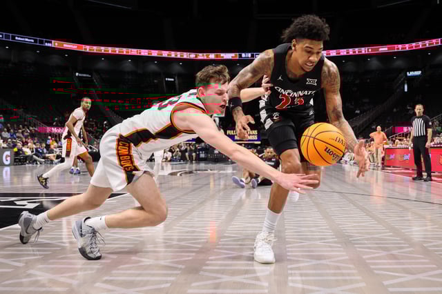 Mar 11, 2025; Kansas City, MO, USA; Cincinnati Bearcats forward Dillon Mitchell (23) and Oklahoma State Cowboys guard Connor Dow (13) go after a loose ball during the second half at T-Mobile Center. Mandatory Credit: William Purnell-Imagn Images
