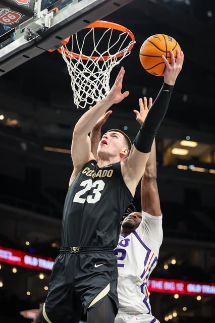 Mar 11, 2025; Kansas City, MO, USA; Colorado Buffaloes forward Andrej Jakimovski (23) shoots the ball around TCU Horned Frogs center Malick Diallo (32) during the second half against the TCU Horned Frogs at T-Mobile Center. Mandatory Credit: William Purnell-Imagn Images