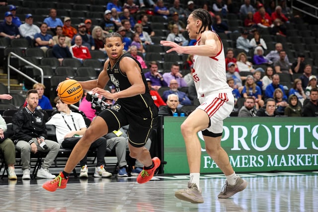 Mar 11, 2025; Kansas City, MO, USA; UCF Knights guard Keyshawn Hall (4) drives to the basket during the second half against the Utah Utes at T-Mobile Center. Mandatory Credit: William Purnell-Imagn Images