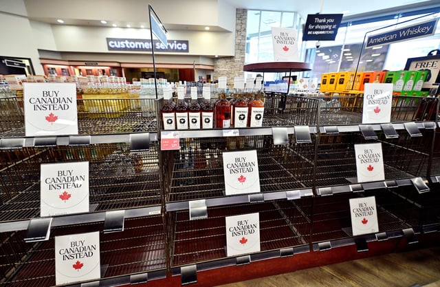 Empty shelves with Buy Canadian Instead signs are seen in the American Whiskey section of the BC Liquor in Vancouver, British Columbia, Canada March 10, 2025. REUTERS/Jennifer Gauthier