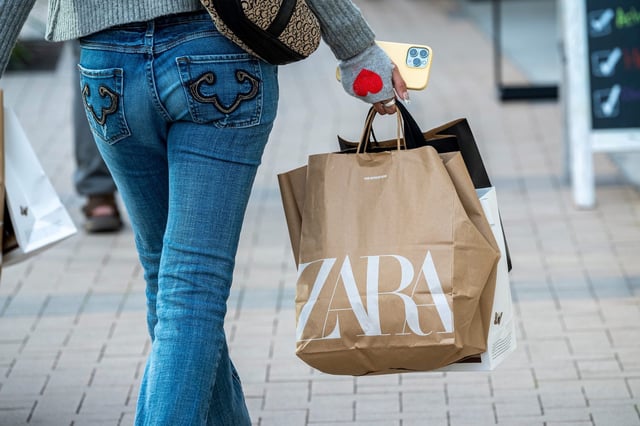 A shopper carrying Zara bags in California.