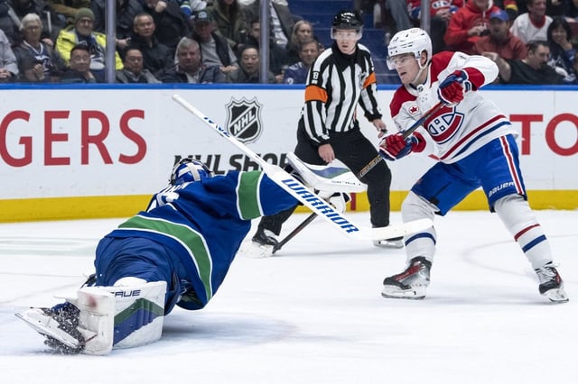 Montreal Canadiens' Cole Caufield (13) scores on Vancouver Canucks goaltender Kevin Lankinen (32) during the second period of an NHL hockey game in Vancouver, B.C., on Tuesday, March 11, 2025. THE CANADIAN PRESS/Ethan Cairns