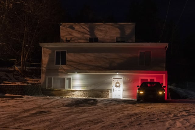 FILE - A private security officer sits in a vehicle on Jan. 3, 2023, in front of the house in Moscow, Idaho, where four University of Idaho students were killed in November 2022. (AP Photo/Ted S. Warren, File)