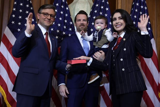 U.S. Speaker of the House Rep. Mike Johnson (R-LA) (L) participates in a ceremonial swearing-in with Rep. Anna Paulina Luna (R-FL) (R), her husband Andrew Gamberzky and her son at the U.S. Capitol on January 3, 2025 in Washington, DC.