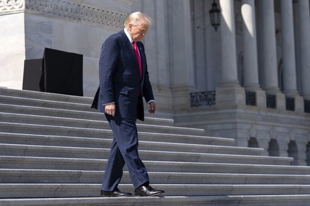 President Donald Trump walks down the stairs after a luncheon with the Speaker of the House Mike Johnson, R-La., and Ireland's Prime Minister Micheal Martin at the U.S. Capitol on Wednesday, March 12, 2025, in Washington. (AP Photo/Jose Luis Magana)