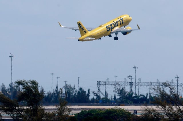 A Spirit Airlines plane takes off within view from the balcony in the support center office building at the new Spirit Airlines Central Campus in Dania Beach on Thursday, April 18, 2024. The campus spans more than 11 acres and features four buildings, including a support center with offices, an amenity building, a new crew training facility built for hands-on experience in flight simulators, and a corporate housing facility. (Mike Stocker/South Florida Sun Sentinel)