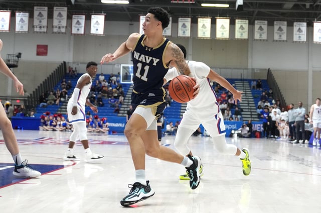 Donovan Draper #11 of the Navy Midshipmen drives to the basket during a college basketball game against the American University Eagles at Bender Arena on March 2, 2024 in Washington, DC.
