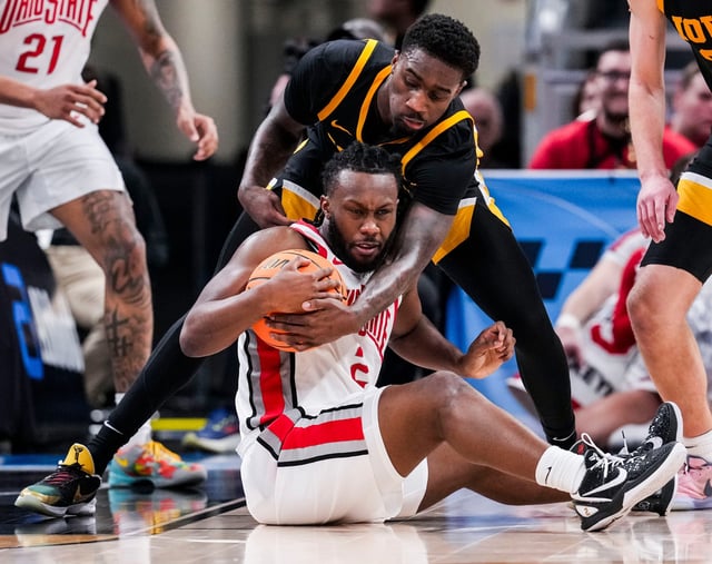 Iowa forward Seydou Traore (7) attempts to grab the ball from Ohio State guard Bruce Thornton during their first-round game of the Big Ten men's basketball tournament at Gainbridge Fieldhouse in Indianapolis.
