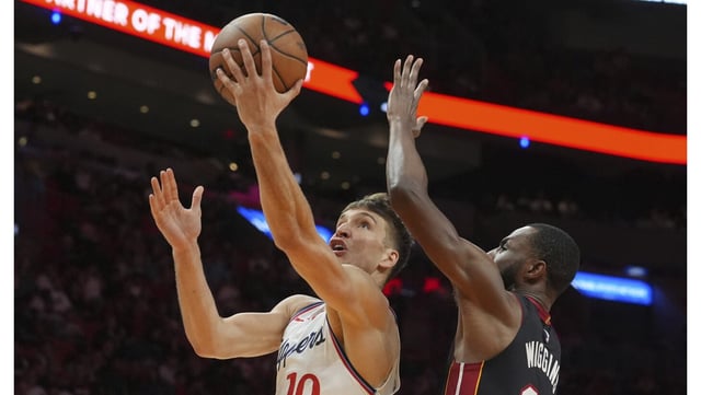 Clippers guard Bogdan Bogdanovic drives to the basket as Miami Heat forward Andrew Wiggins defends during the second half on Wednesday night in Miami. Bogdanovic had a season-high 30 points on 11-of-16 shooting and grabbed 10 rebounds in a 119-104 win. (AP Photo/Marta Lavandier)