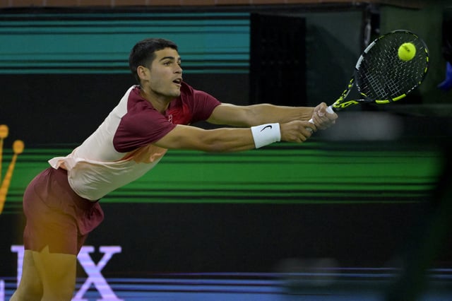 Mar 12, 2025; Indian Wells, CA, USA;  Carlos Alcaraz (ESP) hits a shot as he defeated Grigor Dimitrov (not pictured) in his fourth round match of the BNP Paribas Open at the Indian Well Tennis Garden. Mandatory Credit: Jayne Kamin-Oncea-Imagn Images