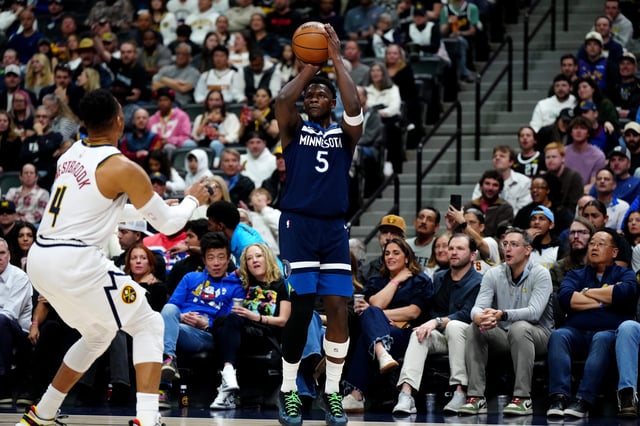 Mar 12, 2025; Denver, Colorado, USA; Minnesota Timberwolves guard Anthony Edwards (5) shoots a three point shot in the first quarter against the Minnesota Timberwolves at Ball Arena. Mandatory Credit: Ron Chenoy-Imagn Images