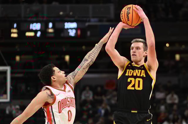 Mar 12, 2025; Indianapolis, IN, USA; Iowa Hawkeyes forward Payton Sandfort (20) attempts a shot over Ohio State Buckeyes guard John Mobley Jr. (0) during the second half at Gainbridge Fieldhouse. Mandatory Credit: Robert Goddin-Imagn Images