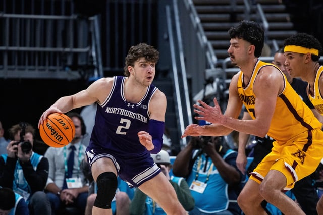 Mar 12, 2025; Indianapolis, IN, USA;  Northwestern Wildcats forward Nick Martinelli (2) dribbles the ball while Minnesota Golden Gophers forward Dawson Garcia (3) defends in the second half at Gainbridge Fieldhouse. Mandatory Credit: Trevor Ruszkowski-Imagn Images