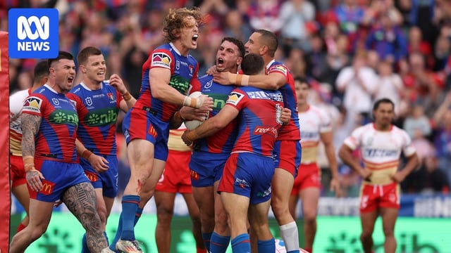 A group of rugby league players celebrate a try 