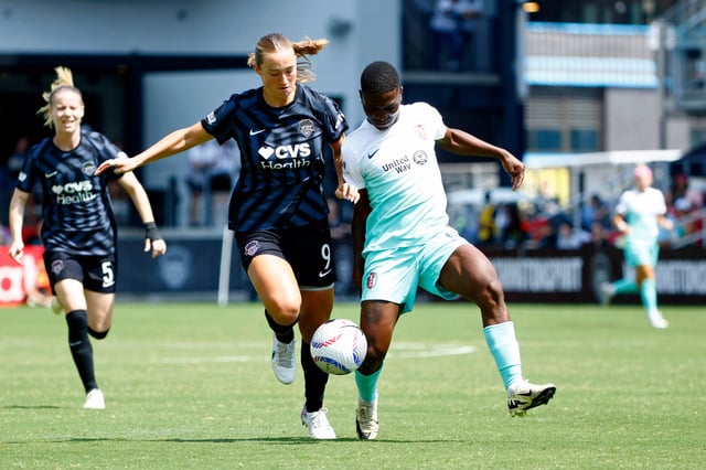 Washington Spirit defender Tara McKeown (9) battles for the ball against Kansas City Current forward Temwa Chawinga (6) at Audi Field.