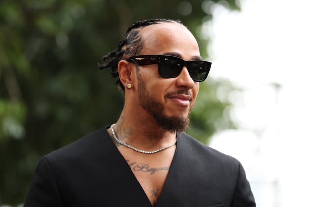 Lewis Hamilton of Great Britain and Scuderia Ferrari looks on in the Paddock during previews ahead of the F1 Grand Prix of Australia at Albert Park Grand Prix Circuit on March 13, 2025 in Melbourne, Australia.